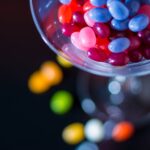 selective focus photography of jelly beans on jar