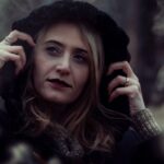 close up photography of woman wearing black hooded jacket