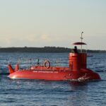 red submarine in body of water