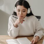 woman in white sweater studying