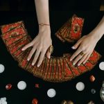 a person holding tarot cards