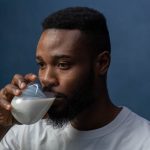 man drinking a glass of milk