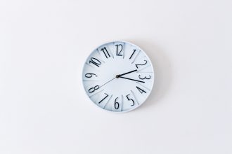 a wall clock on a white wall