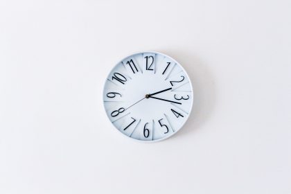a wall clock on a white wall